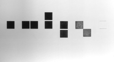 “Of Art Desires...” 1987. Black vatican stone and drawing on wall. Nine units, 8” x 8” x 1/4” each.