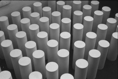 Cluster. 1987. White vatican stone. Eighty nine cylindrical forms. 9” x 3” diameter each.