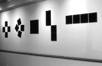 Choreography for a Wall. 1986. Black vatican stone. Twenty units. 8” x 8” x 1/4” each.